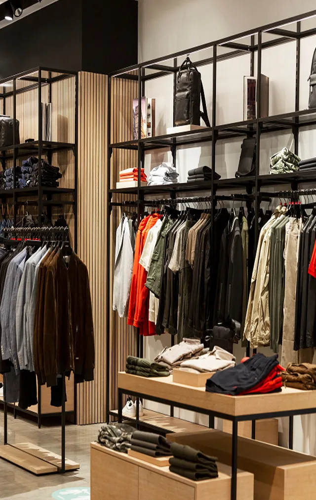 Organized retail store interior with apparel displays and shelving