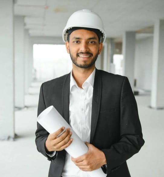 Plant HR leader in a hard hat holding project plans on a construction site